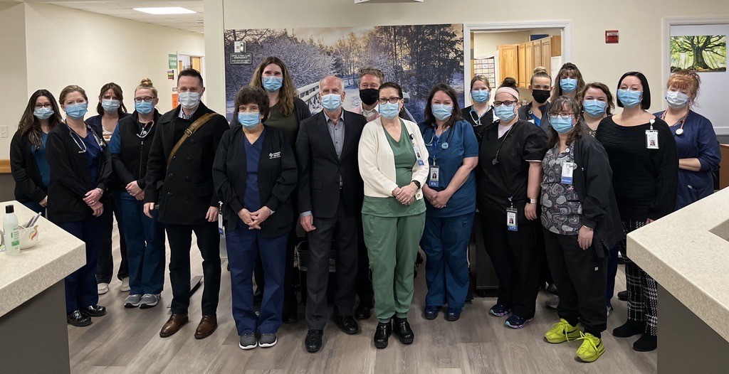 Picture of Peter wearing a mask alongside others from the community health center.